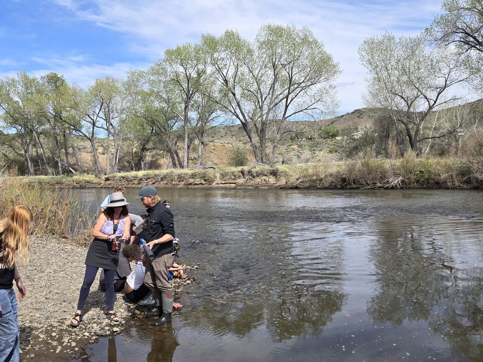 Students and educators deploying water quality monitoring equipment on the Carson River